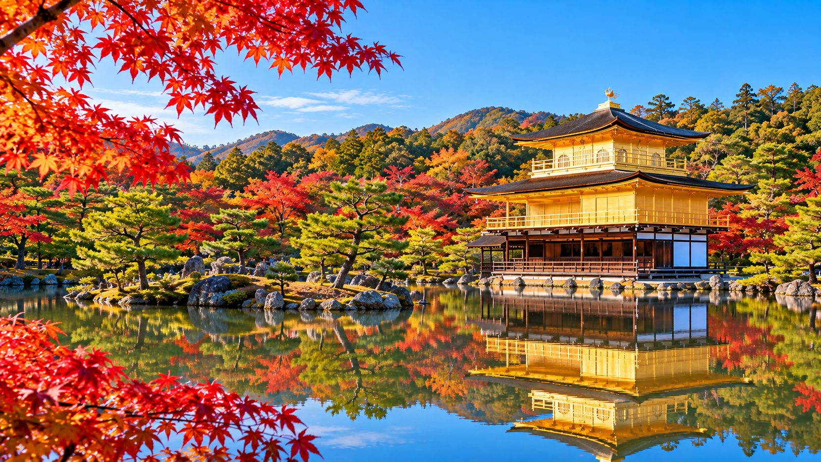 Kinkaku-ji Golden Pavilion in Kyoto reflected in its pond among autumn maples